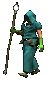 person in a dark green robe holding a staff and walking